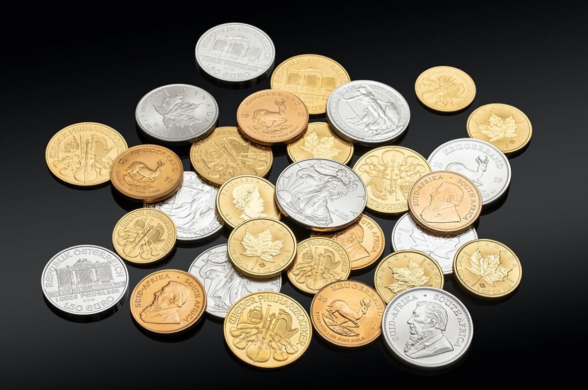 A pile of mixed gold and silver coins stacked together.