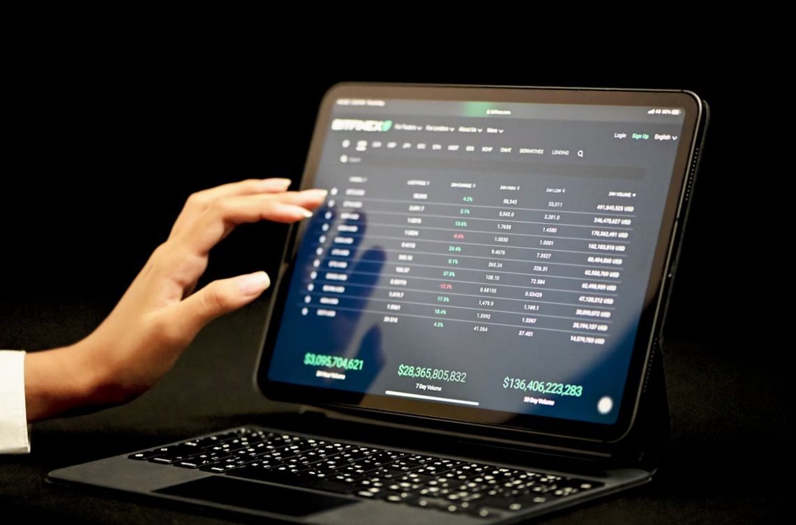 Someone is researching trading data on a laptop.