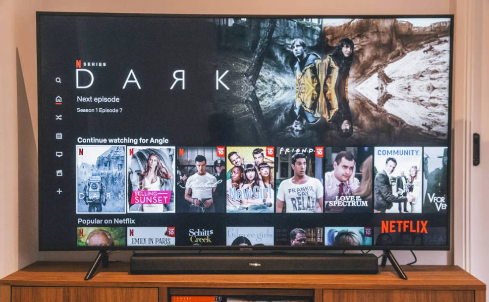 A black flat-screen TV turned on, displaying the Netflix home screen.