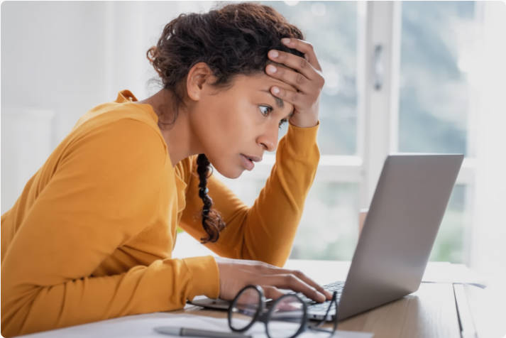 A woman feeling stressed while looking bank account online A woman feeling stressed while looking bank account online