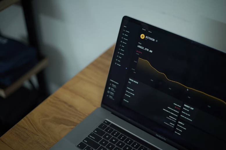 A Laptop on the Desk Showing Bitcoin Price